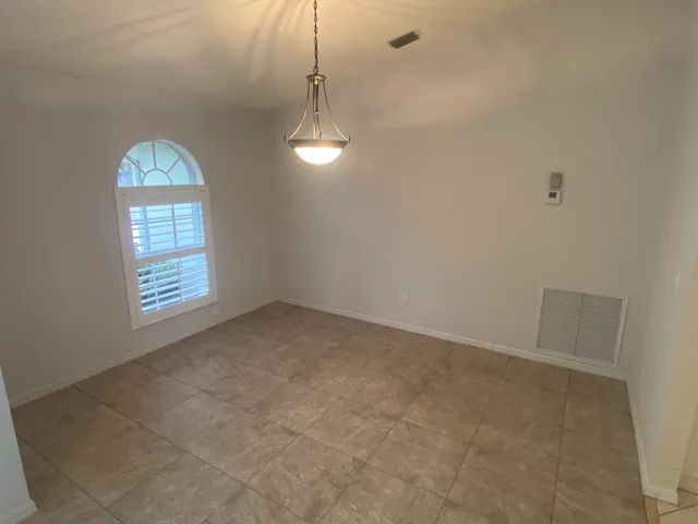 an empty room with windows and entrance