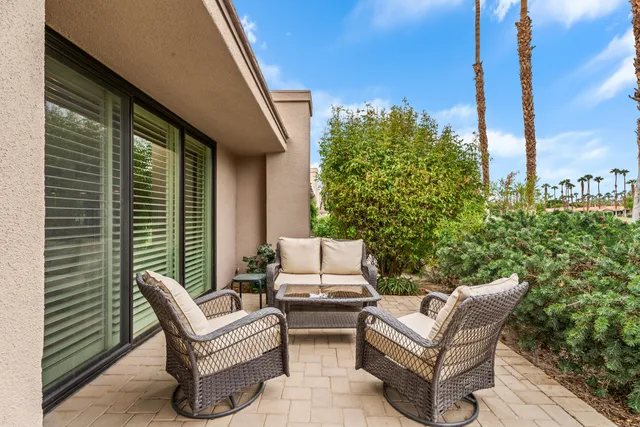 a view of a garden with lawn chairs