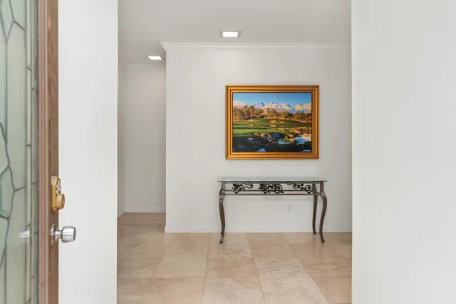 a view of a hallway with two paintings on the wall
