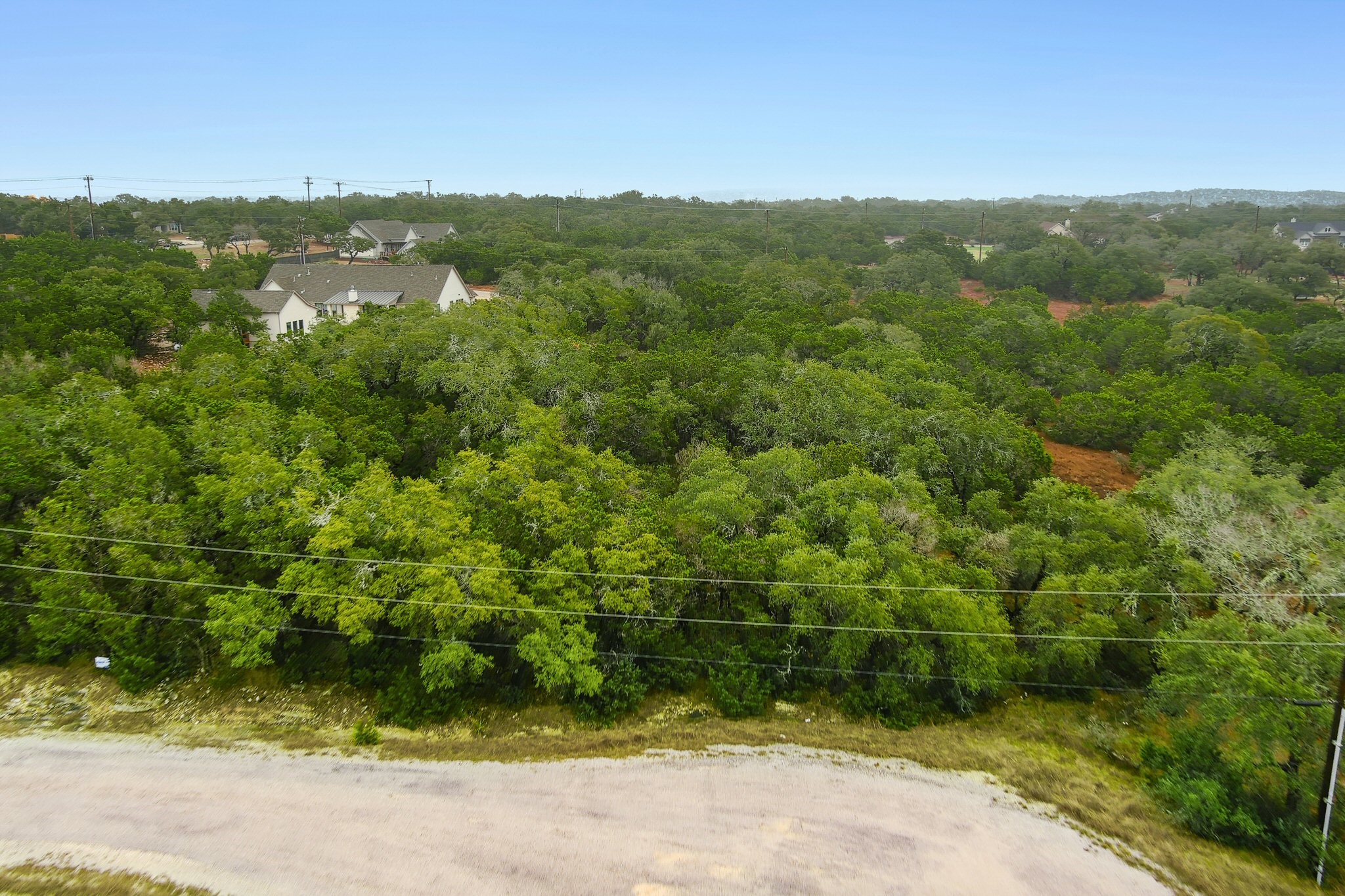 157 Verbena Circle Spring Branch, TX 78070 - Photo 17 of 32 a view of a lush green field with a houses