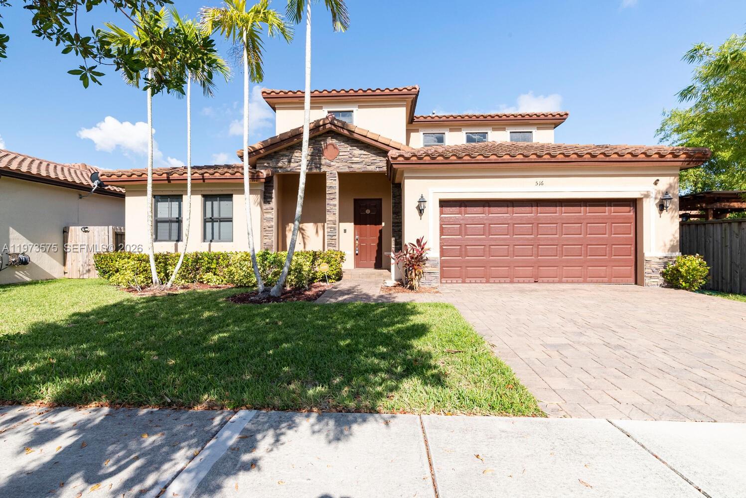 516 Southeast 35th Terrace Homestead, FL 33033 - Photo 1 of 25 a front view of a house with a garden and entryway