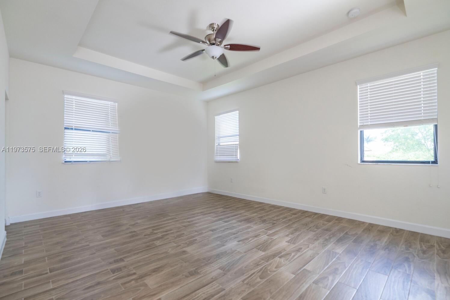 516 Southeast 35th Terrace Homestead, FL 33033 - Photo 11 of 25 a view of an empty room with wooden floor and a window