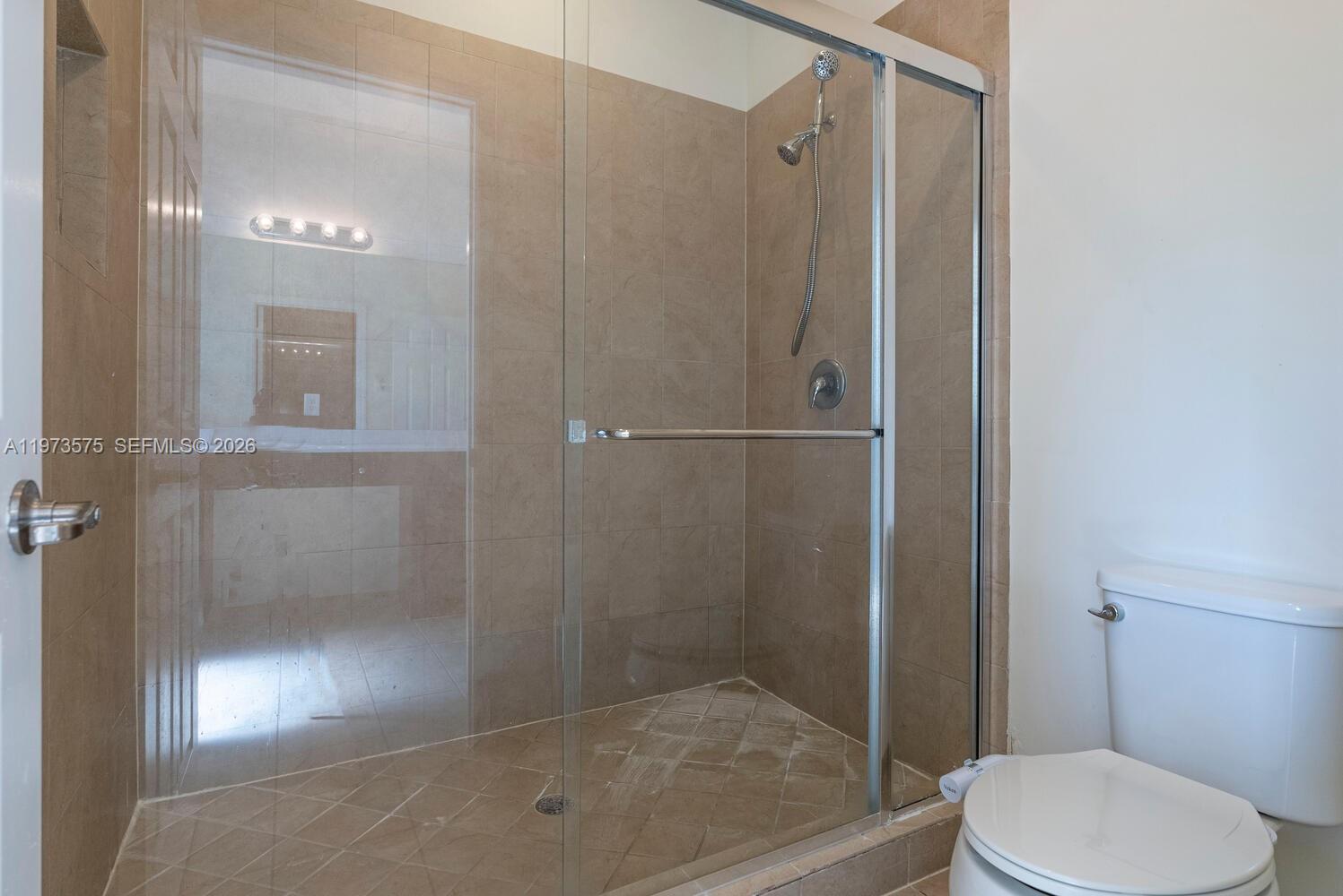 516 Southeast 35th Terrace Homestead, FL 33033 - Photo 14 of 25 a bathroom with a shower a toilet and a sink
