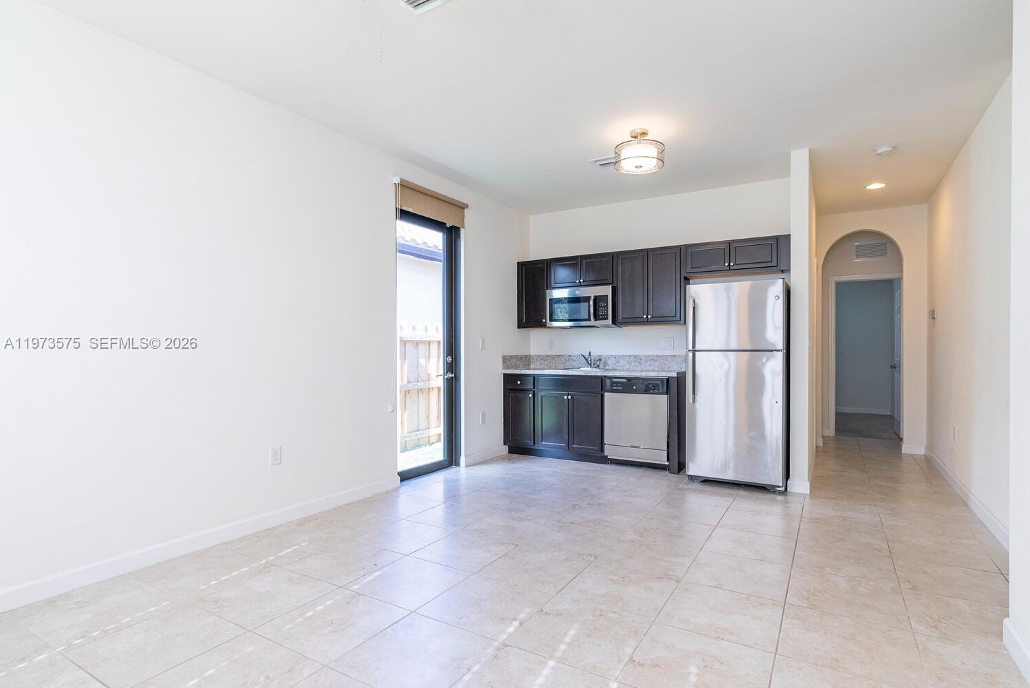 516 Southeast 35th Terrace Homestead, FL 33033 - Photo 18 of 25 a large kitchen with cabinets and stainless steel appliances