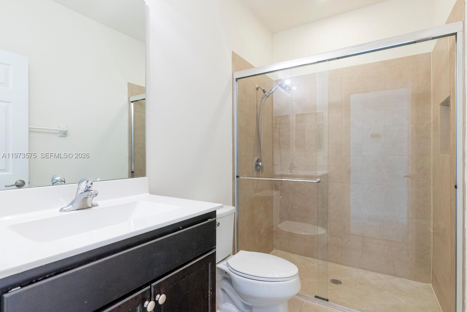 516 Southeast 35th Terrace Homestead, FL 33033 - Photo 20 of 25 a bathroom with a sink mirror toilet and shower