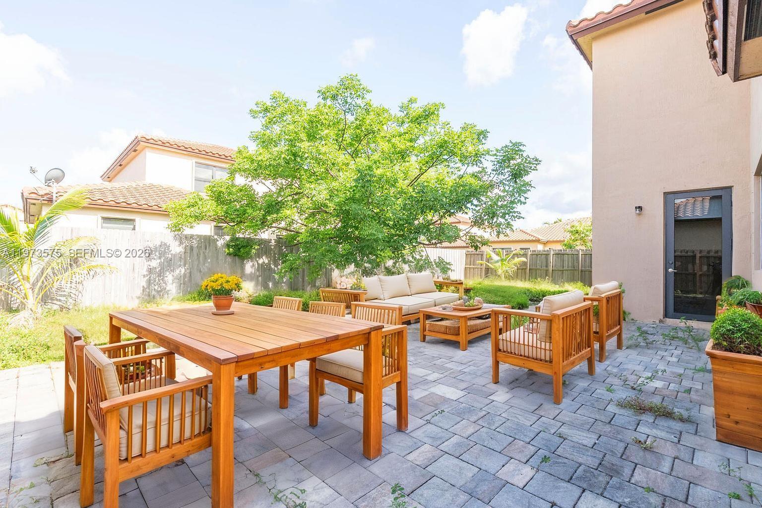 516 Southeast 35th Terrace Homestead, FL 33033 - Photo 23 of 25 a view of a patio with table and chairs and potted plants