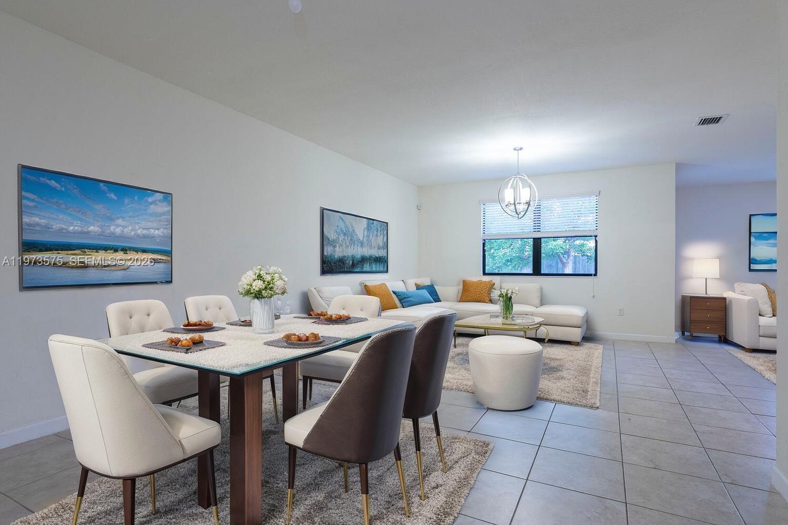 516 Southeast 35th Terrace Homestead, FL 33033 - Photo 4 of 25 a living room with furniture and a table