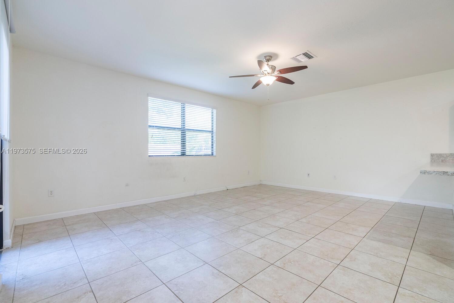 516 Southeast 35th Terrace Homestead, FL 33033 - Photo 8 of 25 an empty room with windows and fan