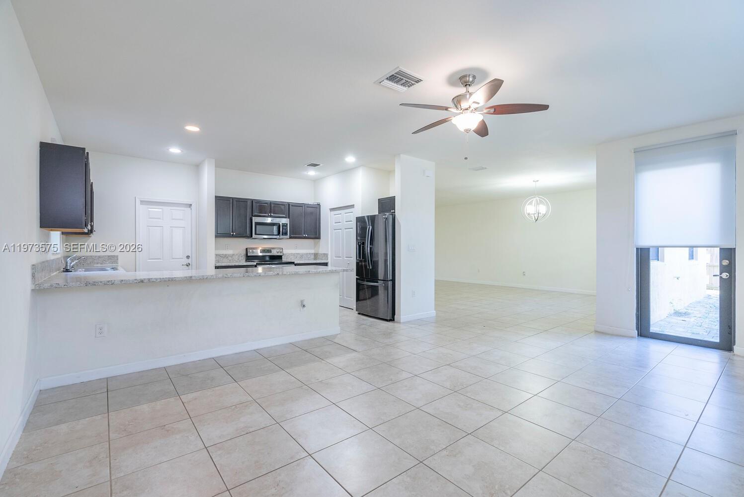 516 Southeast 35th Terrace Homestead, FL 33033 - Photo 9 of 25 a view of kitchen with refrigerator and window