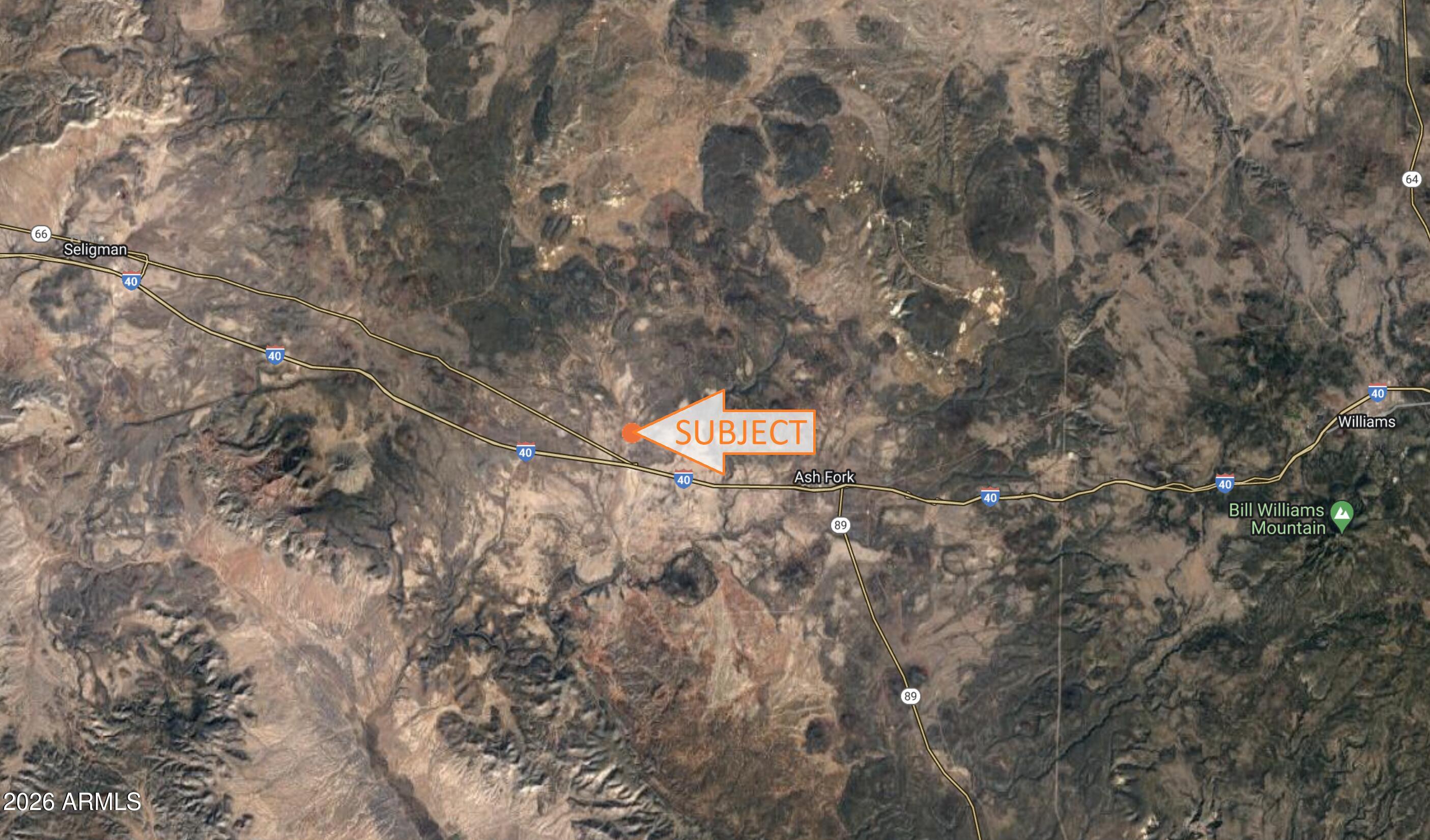 a aerial view of a house with a yard and a tree