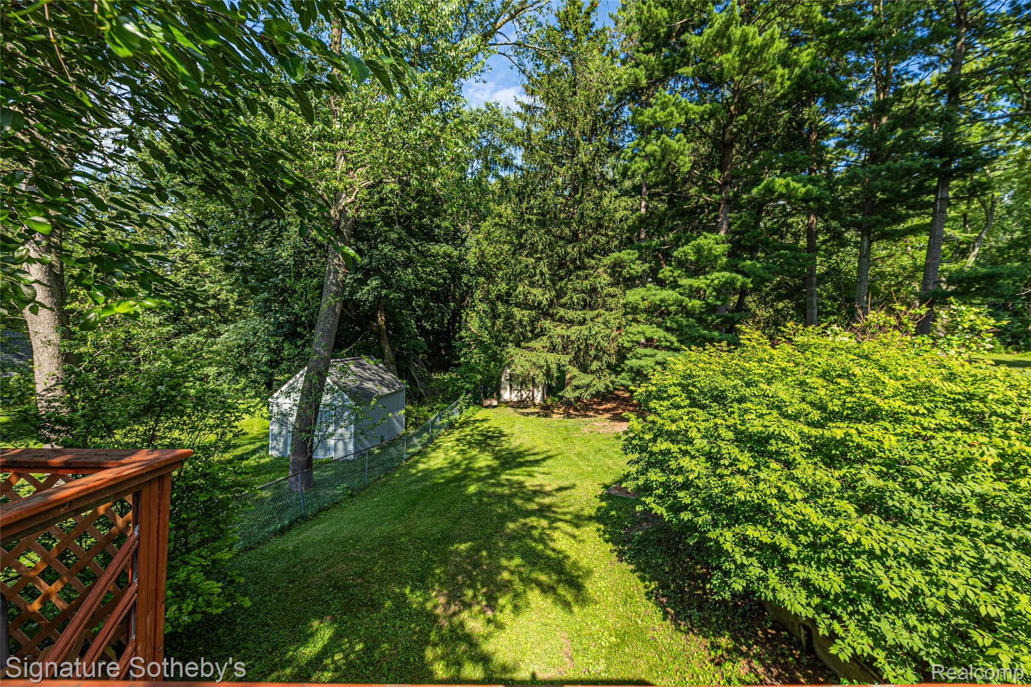 1312 Merry Road Waterford, MI 48328 - Photo 29 of 32 Expansive yard featuring mature trees and lush greenery