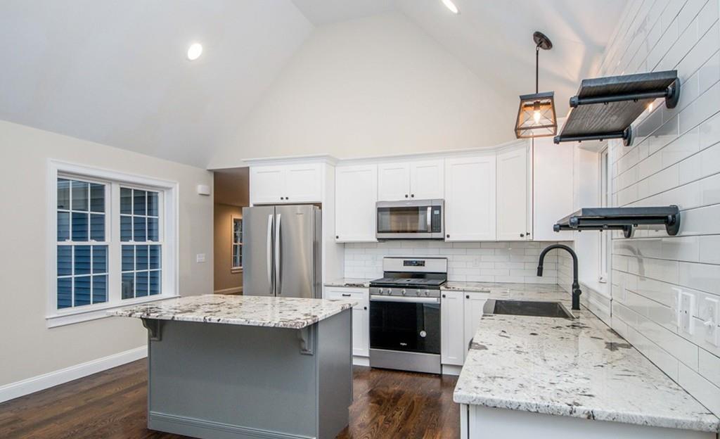 61 Ryder Road Rochester, MA 02770 - Photo 10 of 25 a kitchen with kitchen island stainless steel appliances a stove sink microwave and window