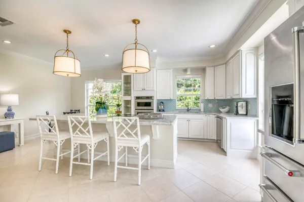 a view of a dining table chairs and chandelier