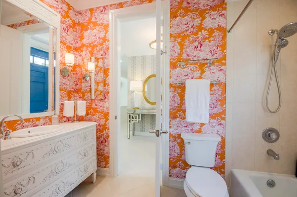 a bathroom with a sink a toilet and shower curtain