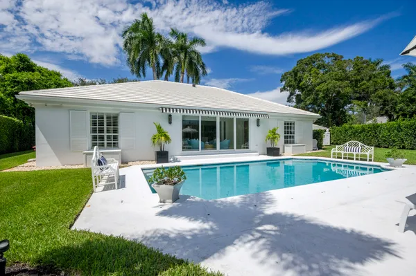 a front view of a house with a garden and patio