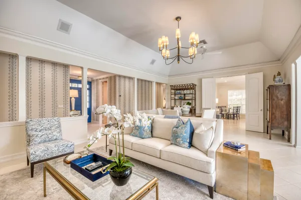 a living room with furniture a chandelier and a chandelier