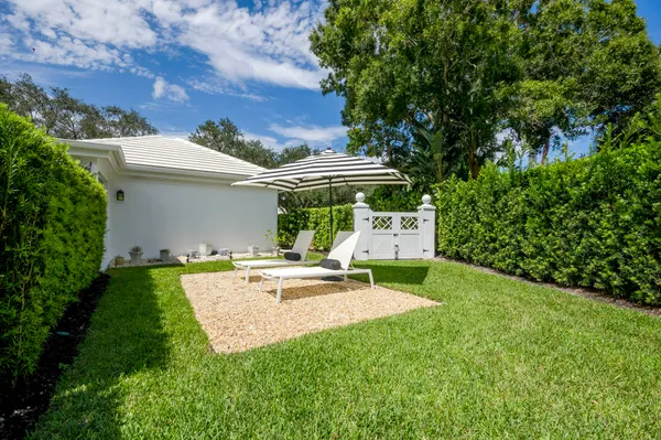 a view of a house with backyard and sitting area