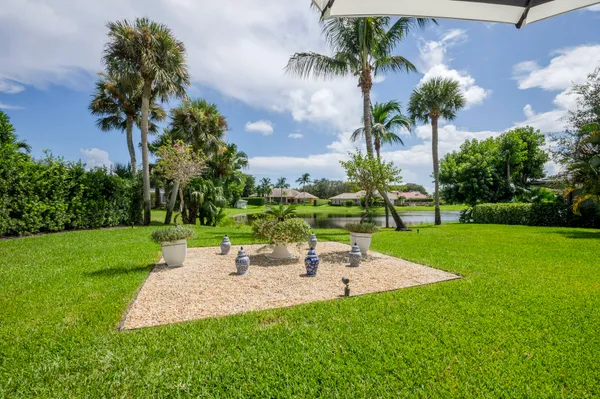 a view of a garden with a table and chairs