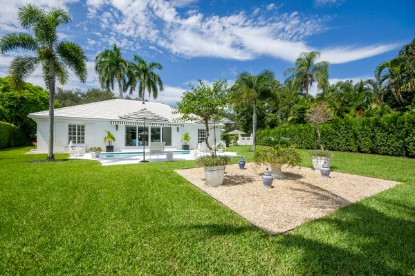 a view of a house with swimming pool and a big yard