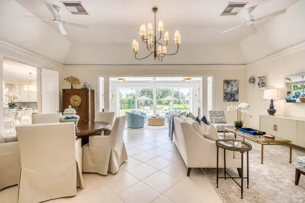 a living room with fireplace furniture and a chandelier