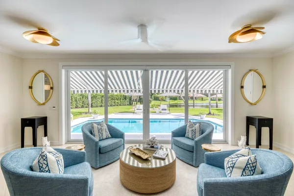 a living room with furniture a fireplace and a large window