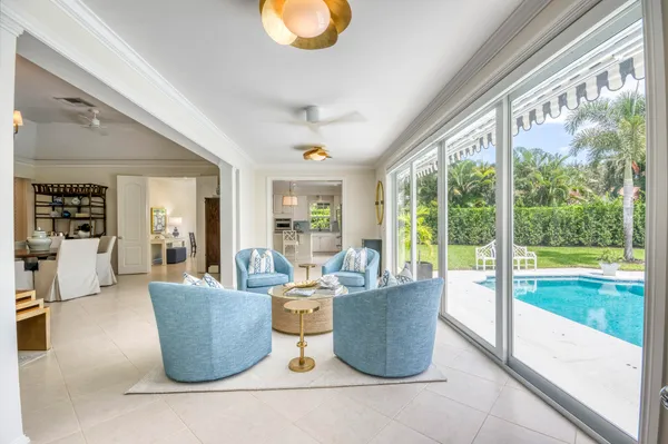 a living room with furniture and floor to ceiling windows