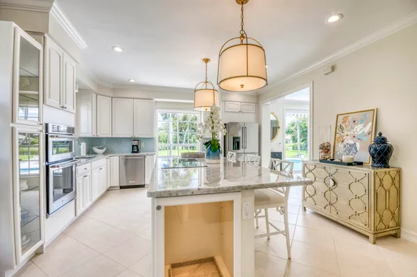 a kitchen with stainless steel appliances granite countertop a stove and refrigerator