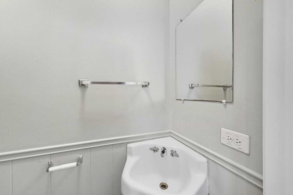 2208 Mission Hill Drive, Unit 103 Austin, TX 78741 - Photo 24 of 26 a bathroom with a sink and cabinets