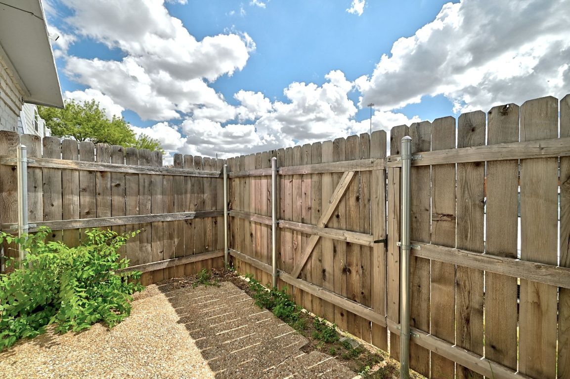 2208 Mission Hill Drive, Unit 103 Austin, TX 78741 - Photo 25 of 26 a view of a backyard with wooden fence
