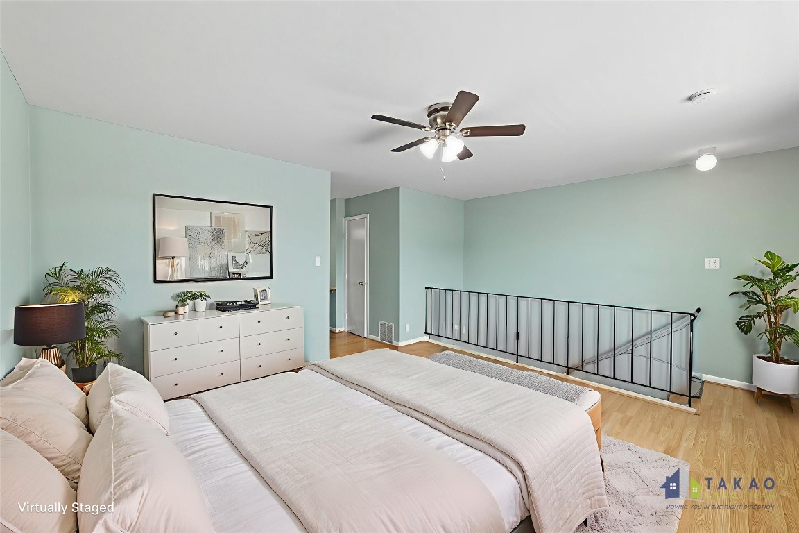 2208 Mission Hill Drive, Unit 103 Austin, TX 78741 - Photo 3 of 26 a bedroom with a bed and a chandelier
