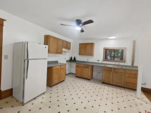 a kitchen with a refrigerator a sink and dishwasher