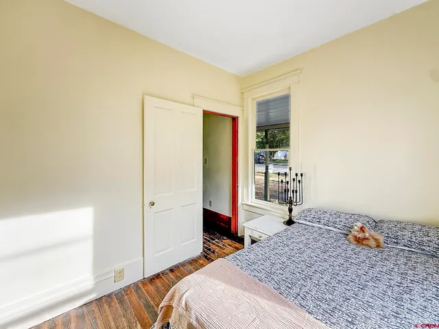 a bedroom with a bed and a dresser in it