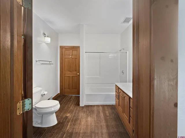 a bathroom with a toilet and a shower