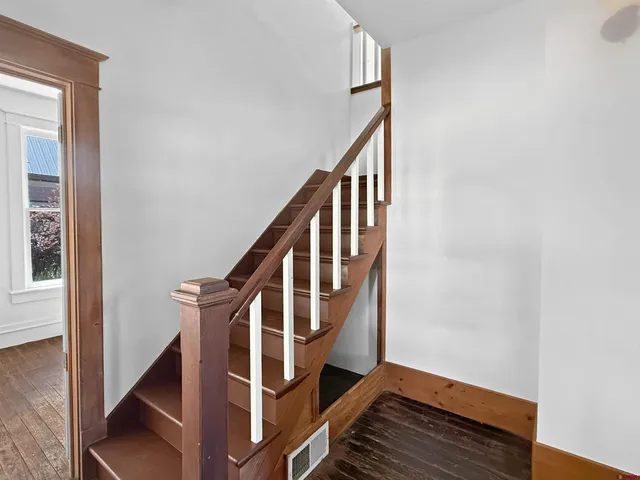 a view of an entryway with wooden floor and stairs