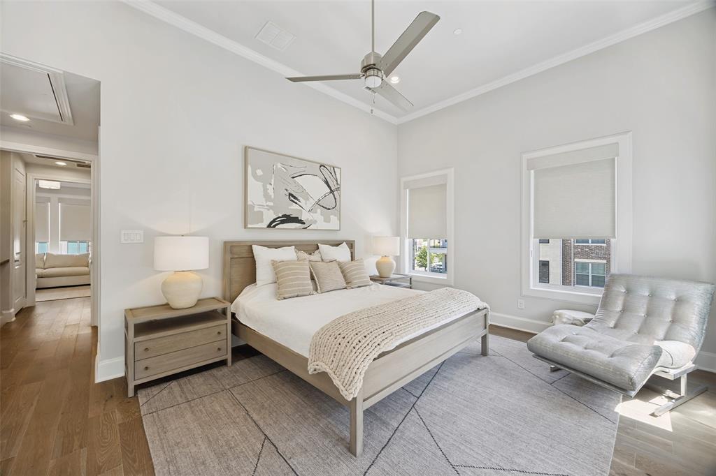 15015 Oak Street Addison, TX 75001 - Photo 15 of 33 a bedroom with a bed and ceiling fan