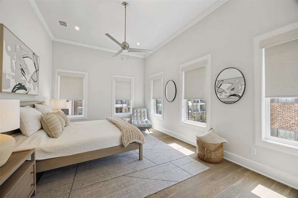 15015 Oak Street Addison, TX 75001 - Photo 16 of 33 a bedroom with a bed a ceiling fan and a window