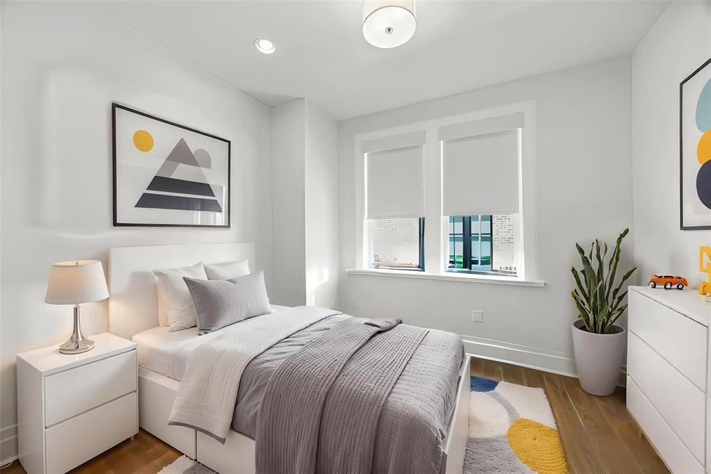 15015 Oak Street Addison, TX 75001 - Photo 20 of 33 a bedroom with a bed and a painting on the wall