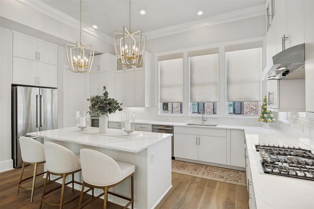 15015 Oak Street Addison, TX 75001 - Photo 2 of 33 a kitchen with center island table and chairs in it