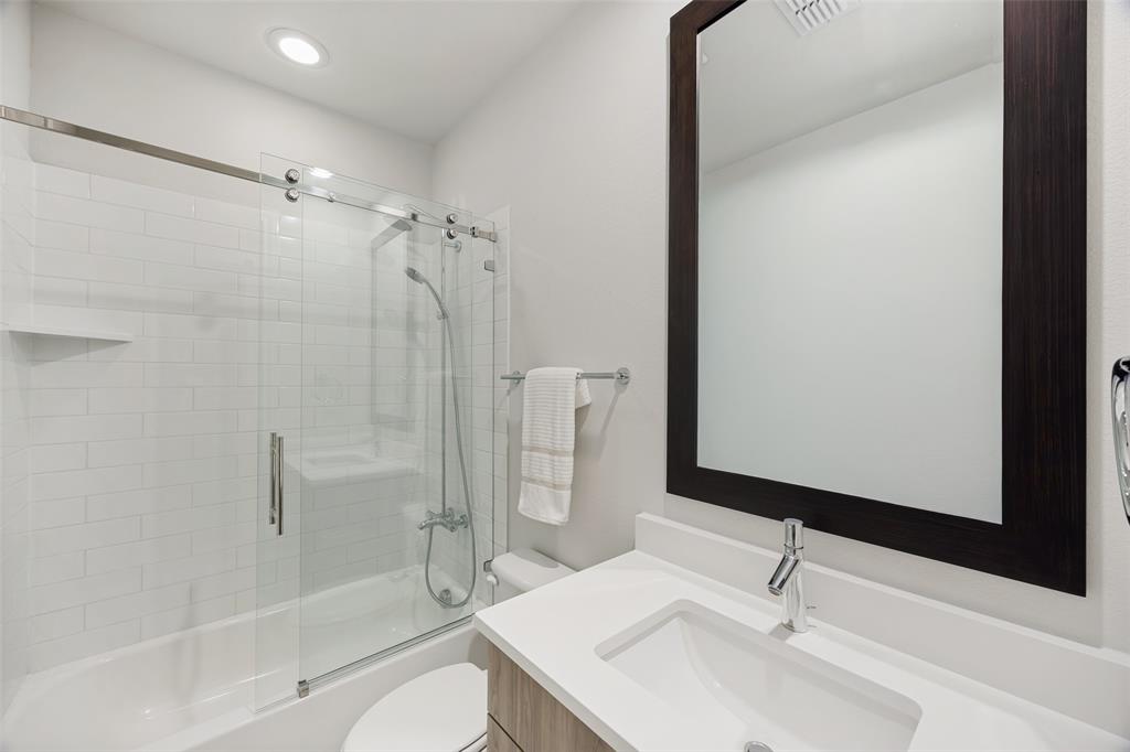 15015 Oak Street Addison, TX 75001 - Photo 22 of 33 a bathroom with a sink toilet and shower