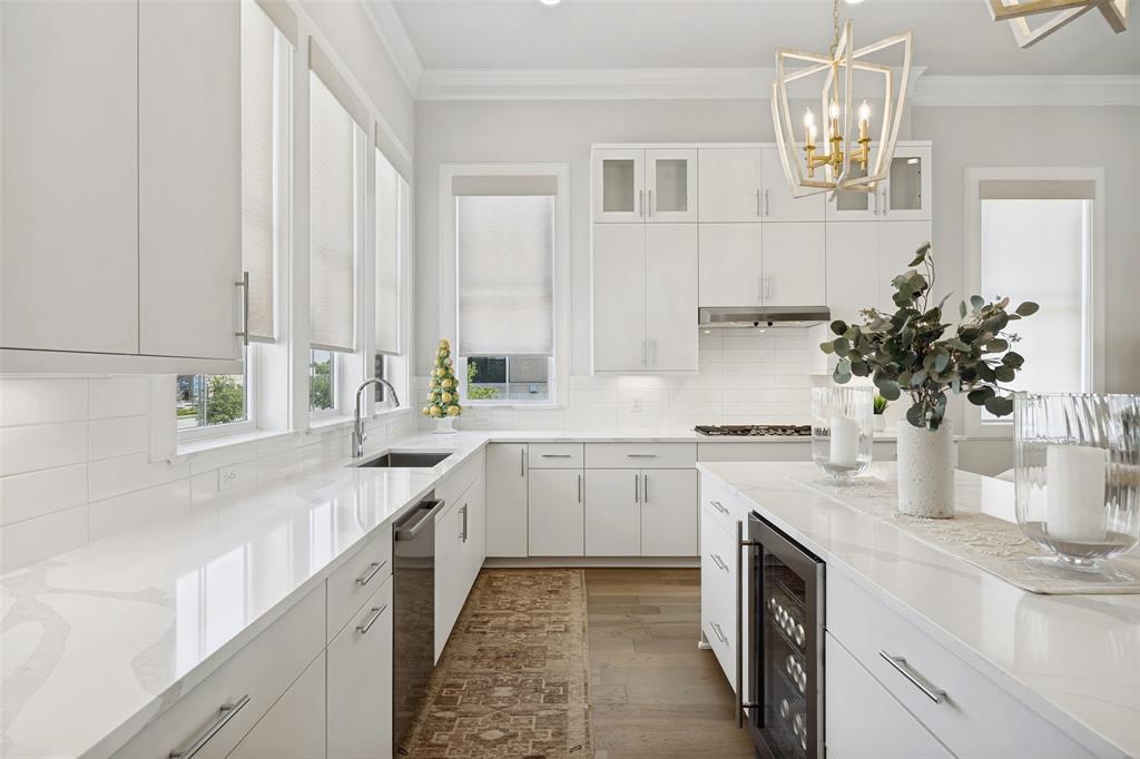 15015 Oak Street Addison, TX 75001 - Photo 3 of 33 a kitchen with a white stove top oven and white cabinets