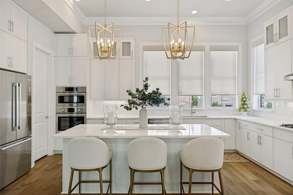 15015 Oak Street Addison, TX 75001 - Photo 4 of 33 a kitchen with stainless steel appliances a dining table chairs and chandelier