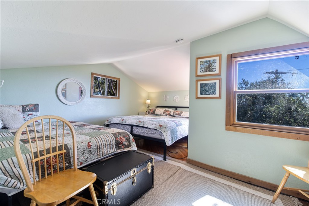 24387 Rocky Point Road Idyllwild, CA 92549 - Photo 27 of 29 a bedroom with furniture and a window