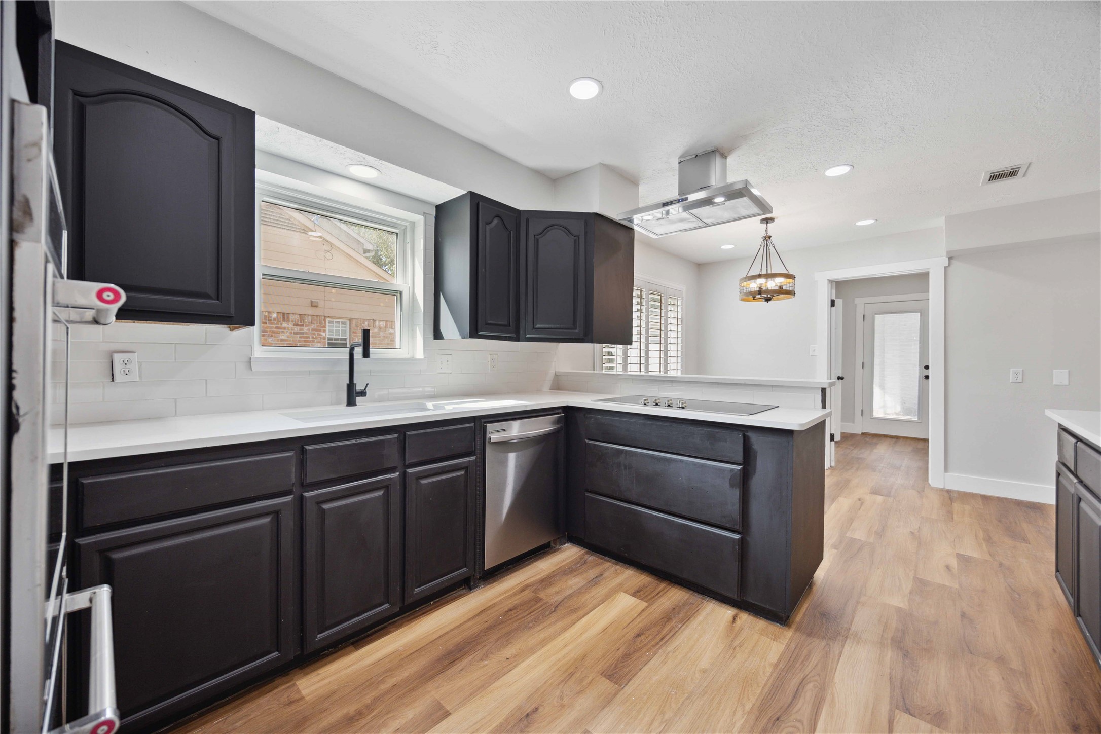 7907 12 Fairway Lane Humble, TX 77346 - Photo 11 of 42 a kitchen with a sink cabinets and wooden floor