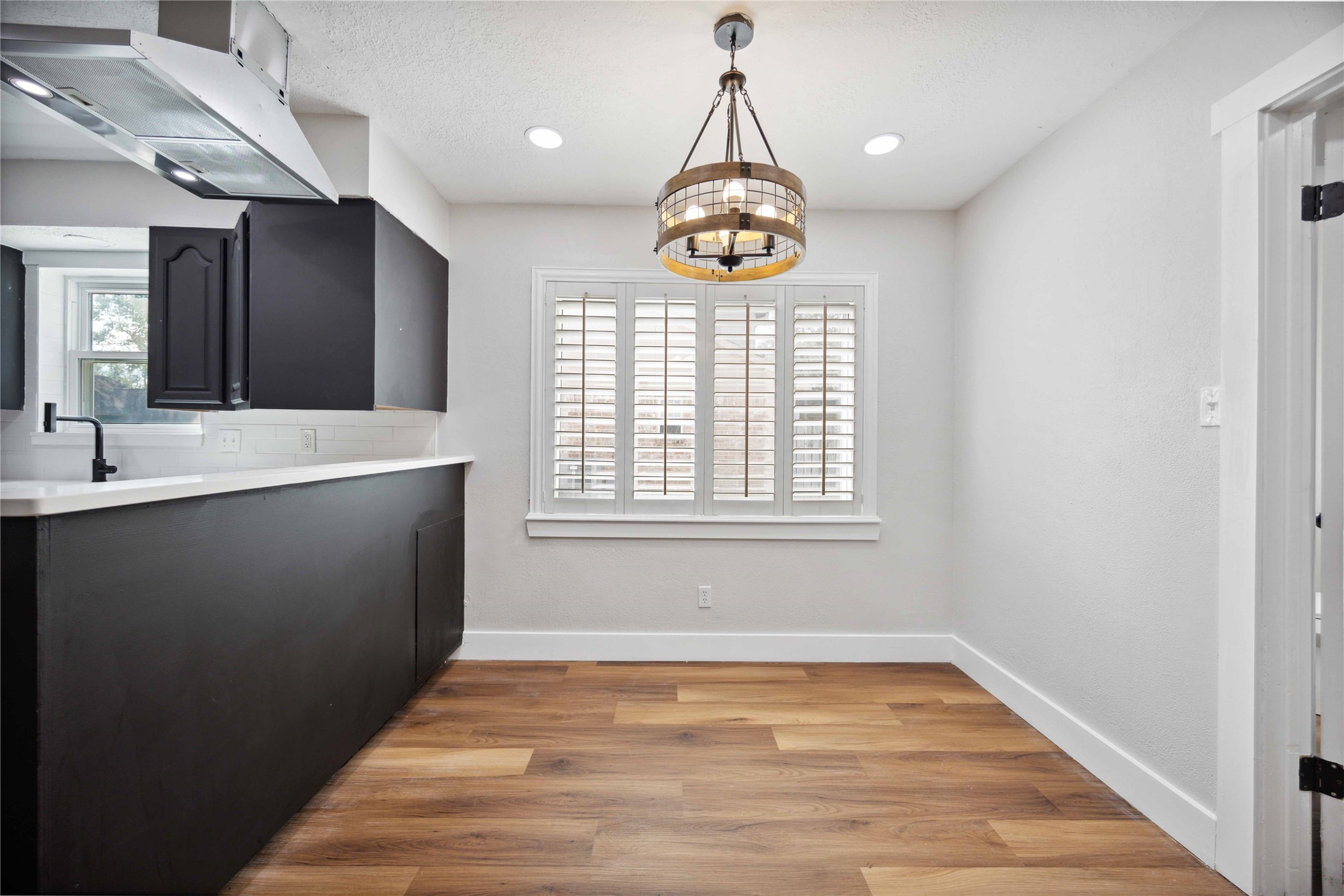7907 12 Fairway Lane Humble, TX 77346 - Photo 13 of 42 a view of an empty room with window and wooden floor