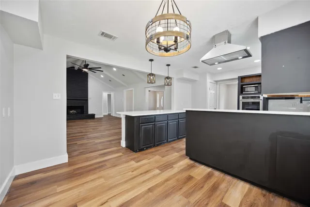 a view of a kitchen with a sink stainless steel appliances and cabinets