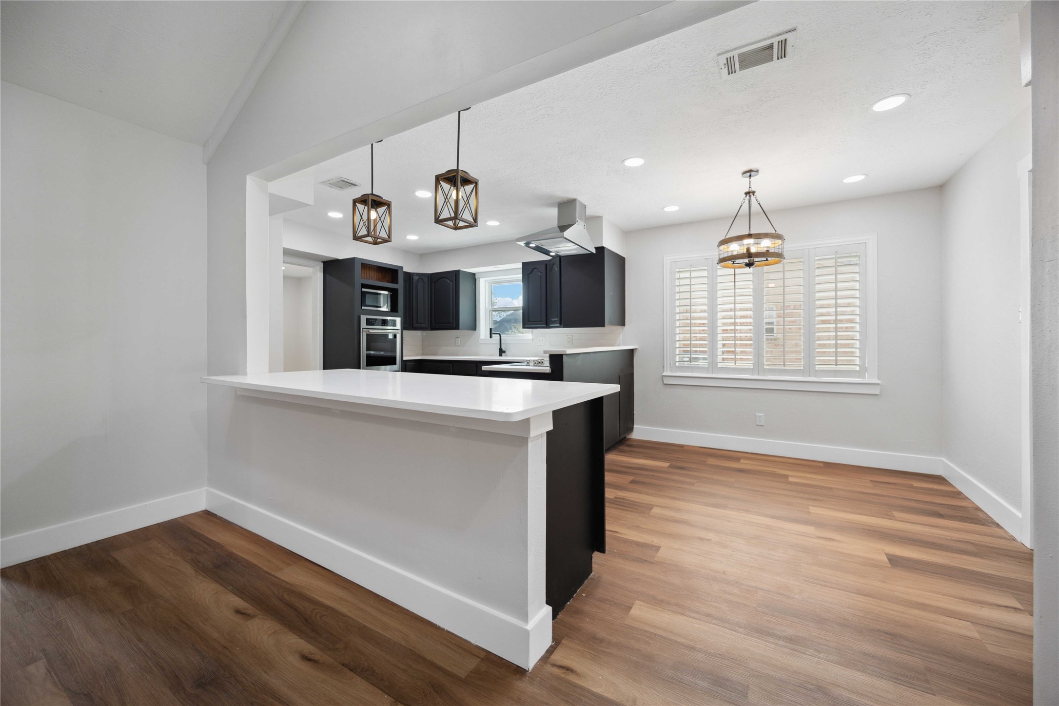 7907 12 Fairway Lane Humble, TX 77346 - Photo 16 of 42 a kitchen with kitchen island white cabinets and window