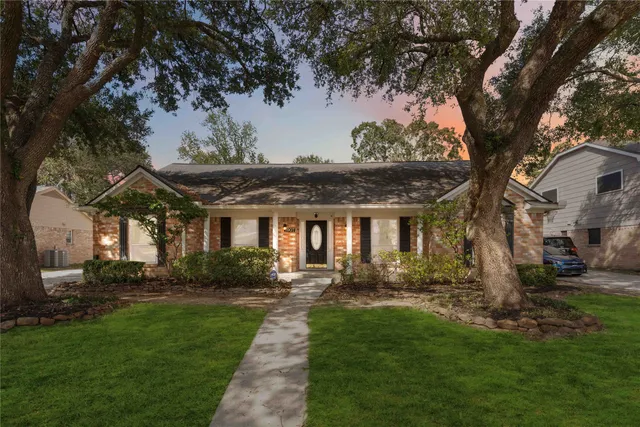 a front view of house with a garden