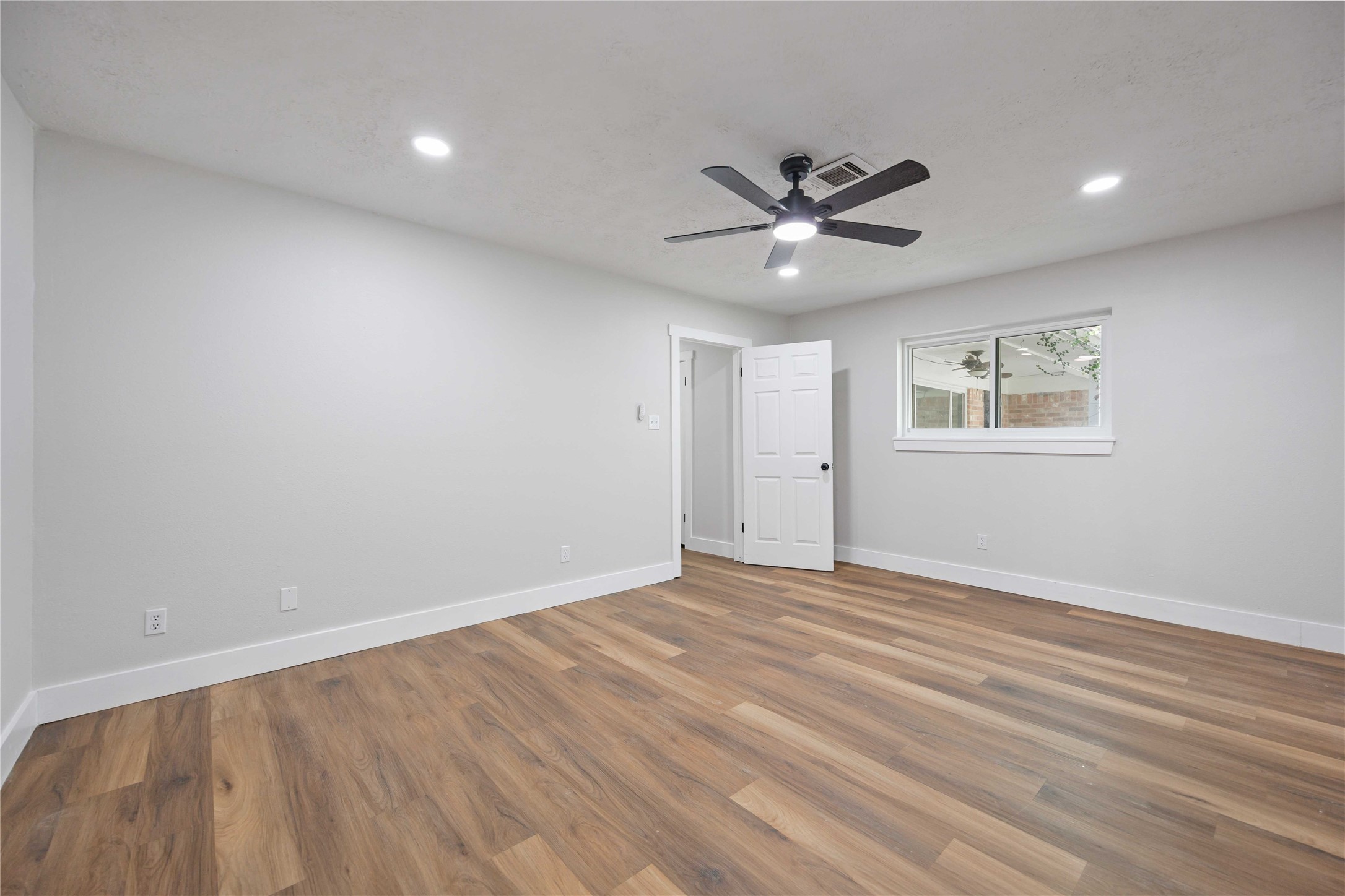 7907 12 Fairway Lane Humble, TX 77346 - Photo 22 of 42 wooden floor in an empty room with a window