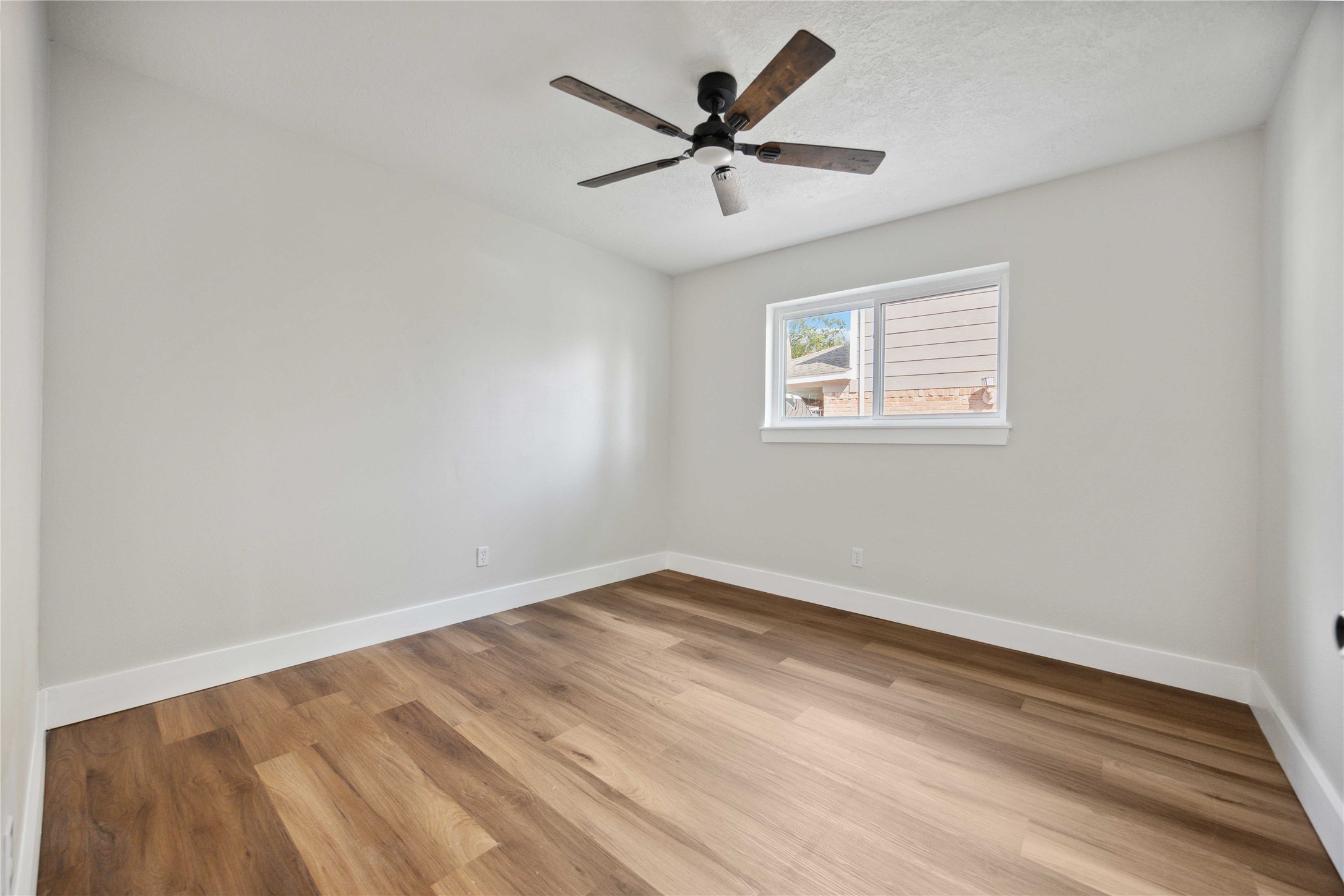 7907 12 Fairway Lane Humble, TX 77346 - Photo 23 of 42 an empty room with wooden floor and windows