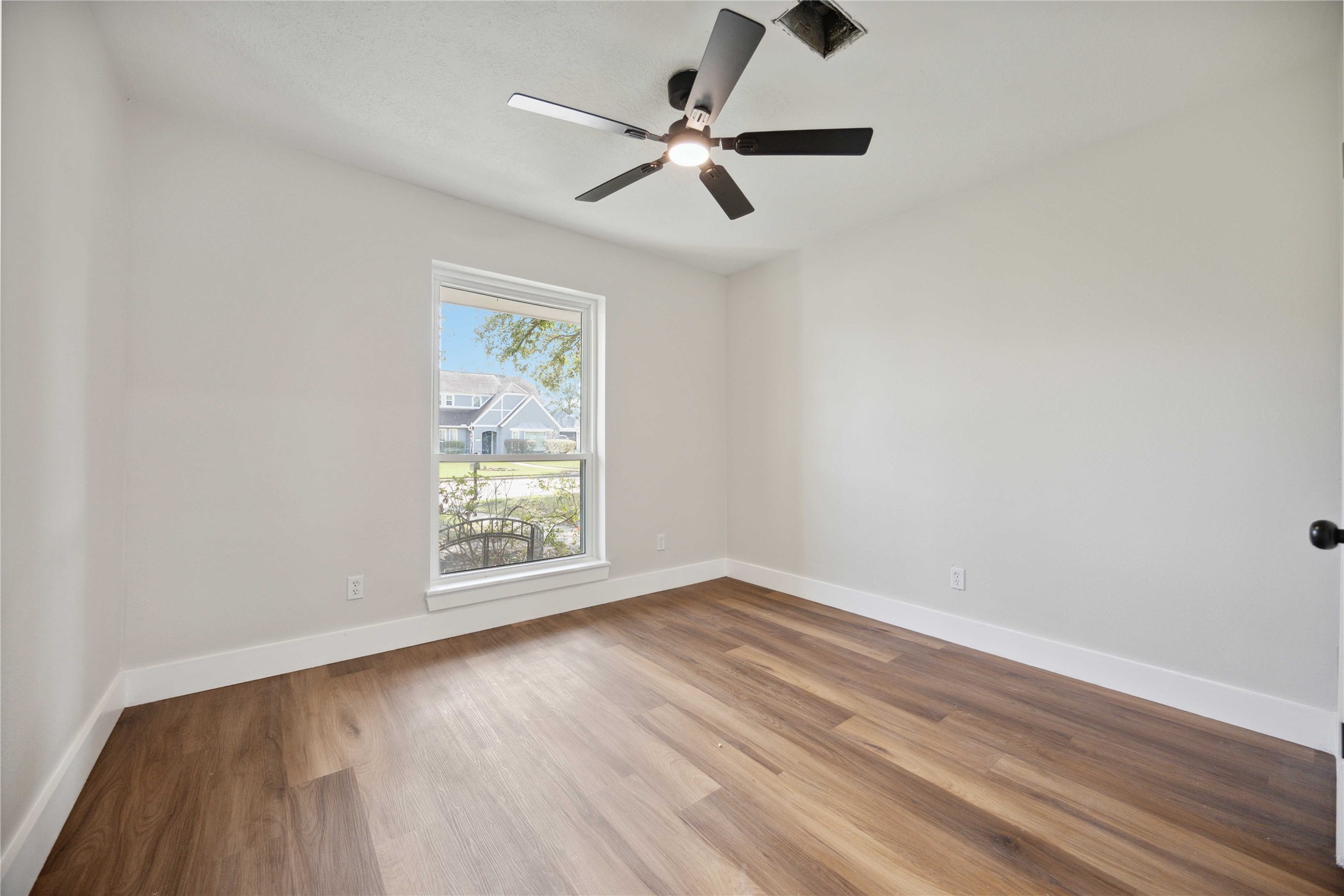 7907 12 Fairway Lane Humble, TX 77346 - Photo 25 of 42 wooden floor in an empty room with a window